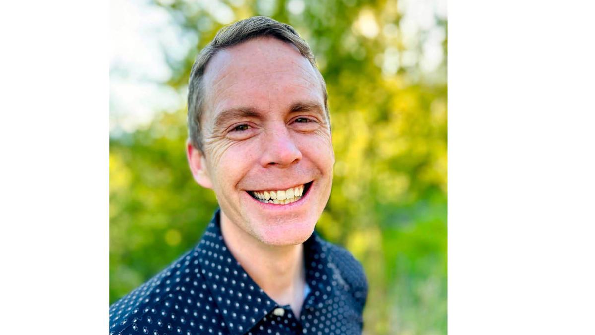 SD8 is pleased to announce the appointment of Mr. Ian Cooper as Principal of L.V. Rogers Secondary School and the REACH program, effective August 1, 2025. A man with short, sandy blond hair and a broad smile stands in front of some green bushes