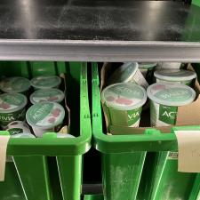Tubs of yoghurt in green crates