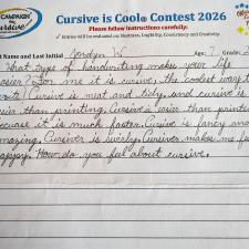 A lined paper with student cursive writing filling part of the page